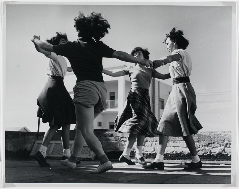 Harvest Holiday/Succoth. Girls dance in celebration on a modern farming settlement in the Palestine desert, Israel, Robert Capa, 1949