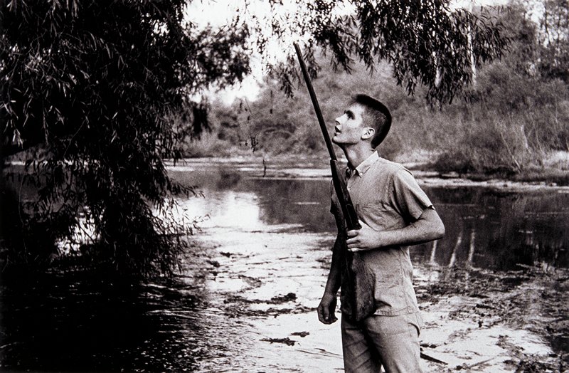 Untitled (man with gun near water), Larry Clark, 1963