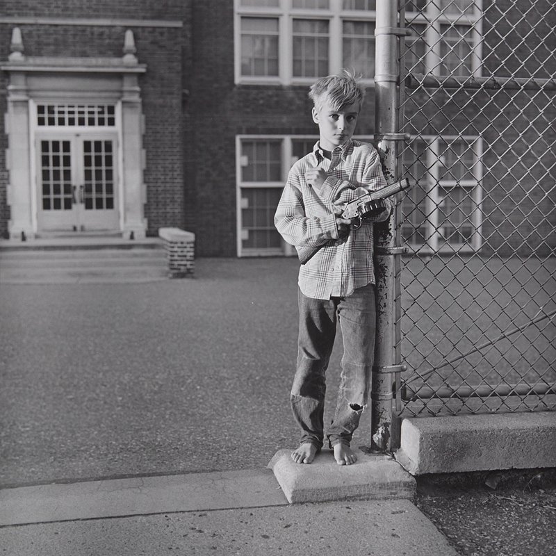 Untitled [boy by fence holding gun, Minneapolis], Mark E. Jensen, c. 1970