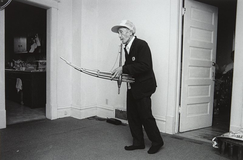 Man Playing the Kheng, Frogtown, Wing Young Huie, 1994