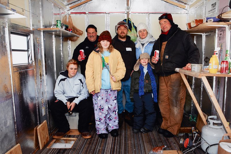 Untitled [Minneapolis. Winter Games. Ice Fishing. Left to right: Tabby Allers, Neil Frandsen, Sammy Diemert, Dan Diemert, Casi Diemert, Gabrielle Diemert, and Joe Johnson.], Martin Parr, 2012