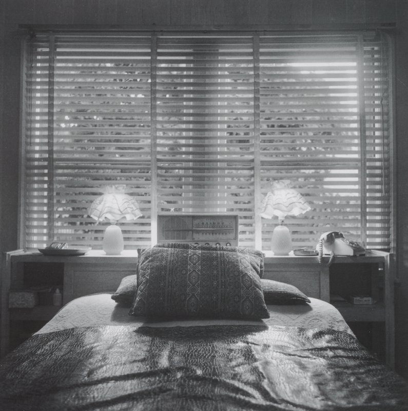 [Bedroom with window, radio, telephone and pair of lamps], Joanne Leonard, 20th century