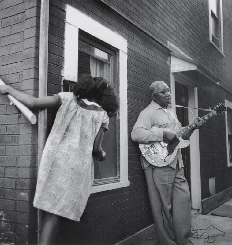 [Man playing electric guitar with girl], Joanne Leonard, 20th century