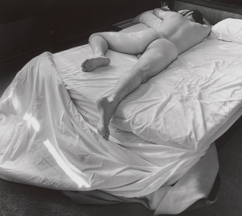 [Nude man lying on bed], Joanne Leonard, 20th century