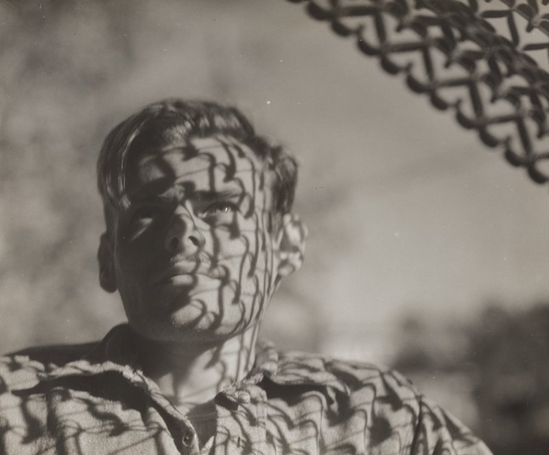 Portrait of man with the shadow of fence on his face, Edward W. Quigley, ок. 1940