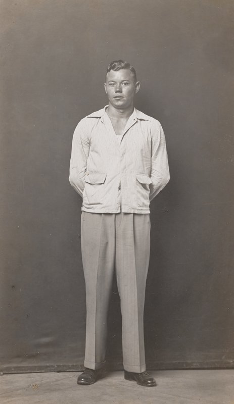 Standing man, hands behind back by Mike Disfarmer