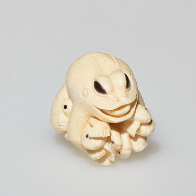 Frog holding fish, 1960s