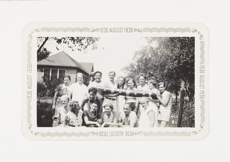 [Group portrait holding large prop outdoors], 1936