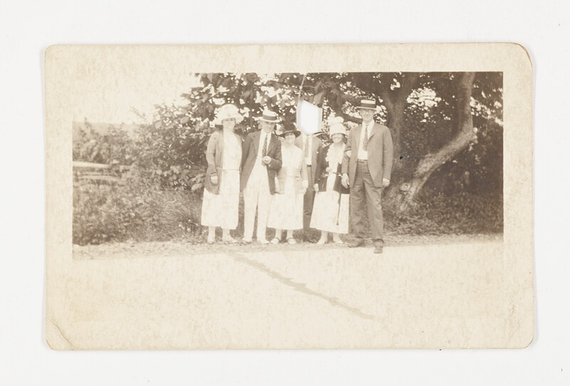 [Group portrait outdoors beneath tree], c. 1920