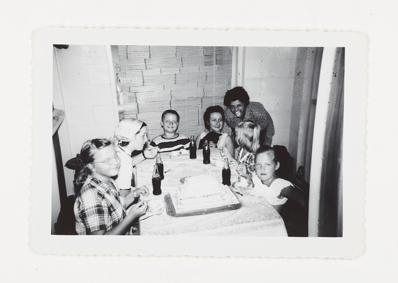 [Children at table with birthday cake], c. 1955