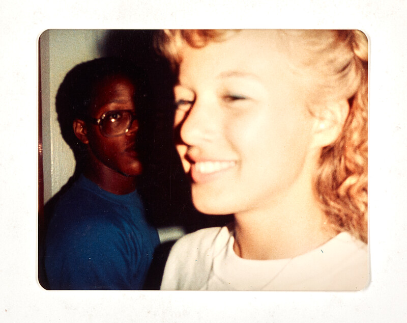 [Two people indoors, close-up snapshot], c. 1985