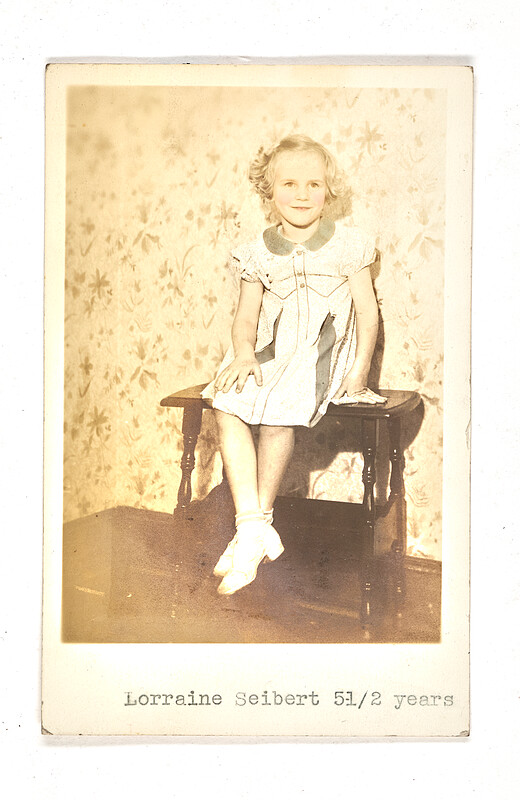 [Seated girl in patterned dress with caption], 1940–50