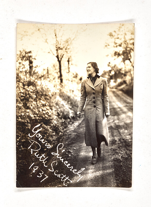 [Woman walking on tree-lined road], 1937