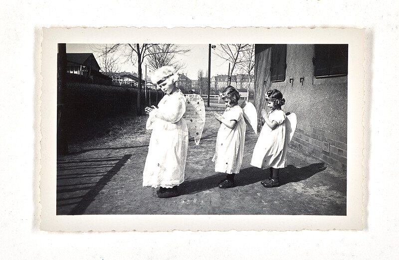 [Three children dressed as angels standing in a row], c. 1955