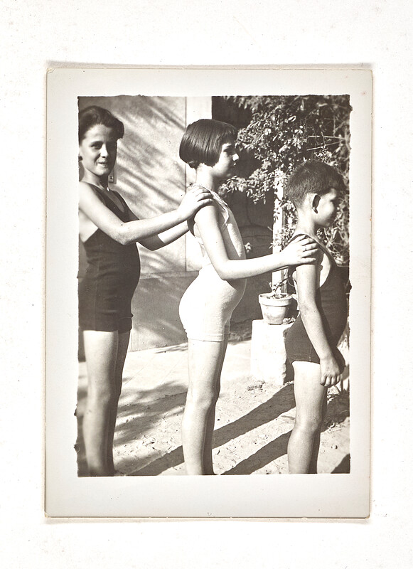 [Three children standing in swimsuits in a row], 1930s–40s