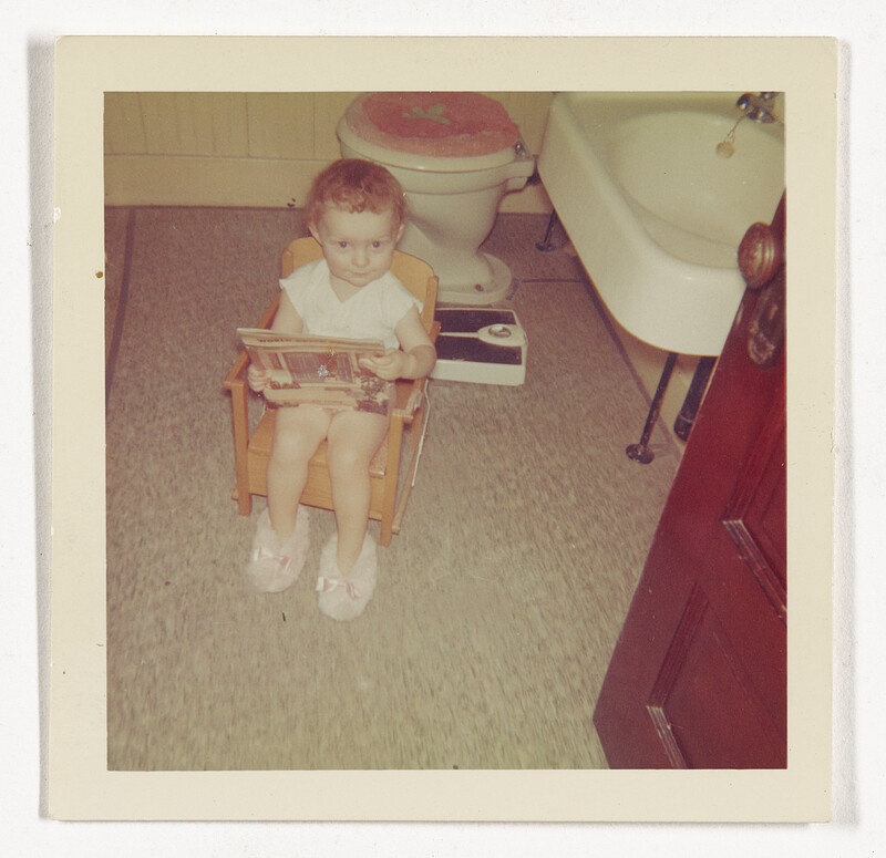 [Toddler reading in bathroom], c. 1960
