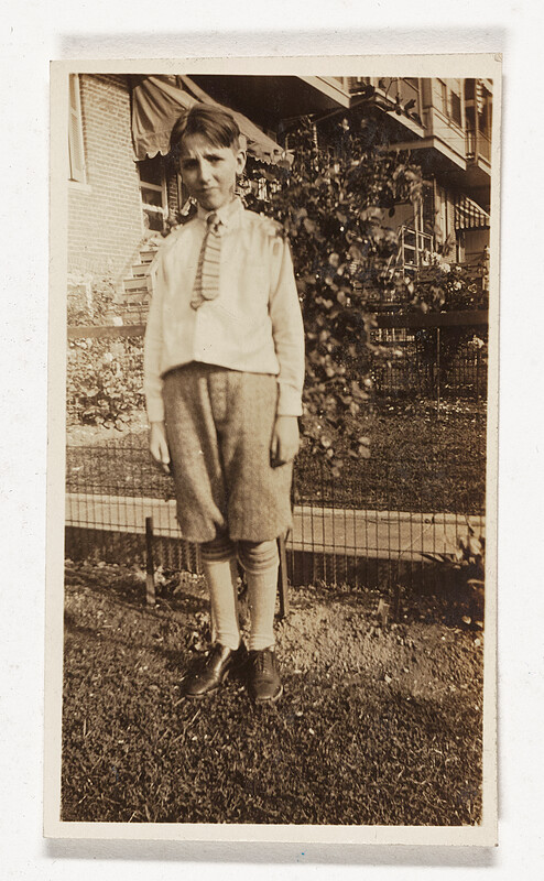 [Boy standing in yard], c. 1920